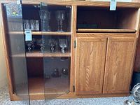 Full view of cabinet front showing glass door section and wood door section