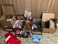 Overview of boxes with various Christmas decorations on floor