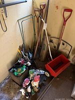 Overall lot with long-handled tools, spreader, gnomes, hand tools in box