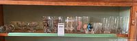 Full shelf showing entire assortment of glasses and figurines