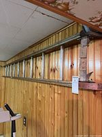 Full view of ladder hung on paneled wall