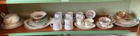 Shelf with mugs, plates, teacups, soup cup