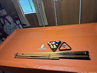 Table surface with cues, racks and balls