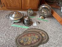 Group shot of all silver-plated serveware and placemats