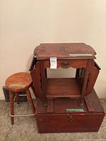 Overall view of side table on chest with stool beside