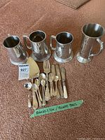 Overview of lot with four tankards and assorted Rogers flatware