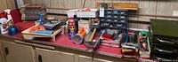 Overall lot on workbench showing tools, organizer, books, paint tray, cans