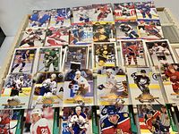 Upper layer of hockey trading cards showing assorted brands, teams and players