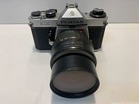 Front view of Asahi Pentax KX body with 28-80mm lens attached