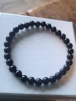 Entire bracelet laid flat showing all black onyx beads