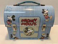 Front of Mickey Mouse lunchbox showing graphics, latches and handle