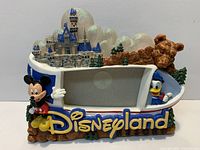 Front view showing Disneyland Resort resin frame with Mickey, Donald, castle, photo opening