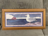 Overall view of framed nautical print with seagull and sailboat