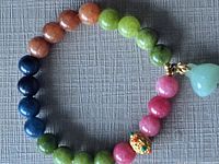 Bracelet laid flat showing bead colours, Pixiu bead and jade charm