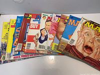 Stack of 10 MAD magazines fanned out showing various covers