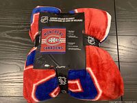 Rolled Montreal Canadiens velour blanket with cardboard sleeve