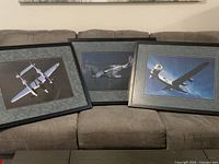 All three framed aircraft prints displayed together on sofa