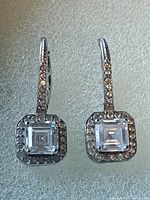 Front view of both earrings showing square Swarovski centers and pavé halos