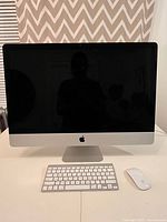 Front view of 27-inch iMac with keyboard and mouse on desk