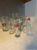 All eight beer glasses grouped on countertop