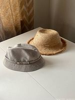 Both hats side by side on table