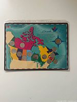 Front of colour map card displaying twelve mounted commemorative quarters