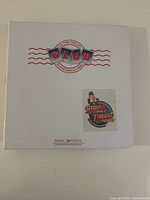 Front cover of white binder with Club logo