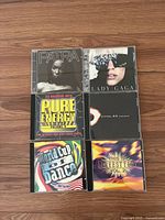 Front covers of all six CDs arranged 2×3 on wood floor