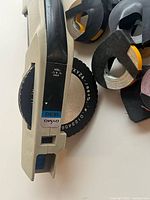 Close view of DYMO 1530 label maker dial and partial tapes