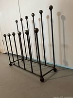 Overall view of rack showing staggered rod heights and ball finials