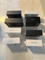 Eight iPhone boxes arranged spine-up showing model names
