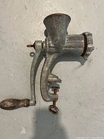 Side view of Alexanderwerk No.5 hand-crank grinder showing handle, body, clamp screw