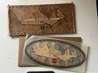 Outer map-design cardboard sleeve, inner oval coin holder and mailer