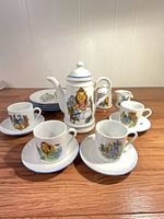 Group shot of entire tea set showing teapot, cups, saucers, plates, sugar bowl
