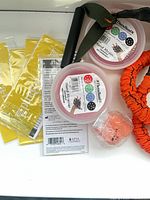 All items laid out: sealed yellow loops, covered tube with handle, Hand Xtrainer packaging, squeeze ball