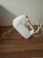 Side view of Toastmaster hand mixer with cord and beaters attached