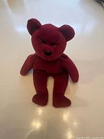 Front view of burgundy Ty Beanie Babies bear plush
