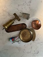 All six vintage metal items on countertop
