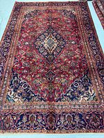 Full view of entire rug showing field, borders and overall design