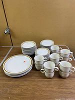 Stacked dinner plates, small plates, bowls, cups and saucers displayed together