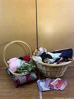 Both wicker baskets filled with fabrics, yarn, jar and patterns