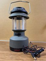 Front view of Coleman rechargeable lantern with adapter cord visible