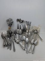 Overall lot view showing variety of flatware pieces