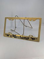Front view of brass Mustang license plate frame