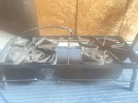 Full view of two-burner propane stove showing frame, burners and hose