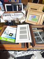 Overall view showing digital frame manual, multiple wooden frames, Family & Friends board, bag of discs