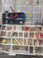overall view of organizer showing beads, findings, jewelry pieces, pliers