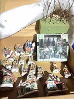 Overview of ceramic houses, boxed accessory set and foam base in carton