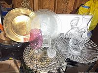 Group view of platters, goblets, decanters on shelving
