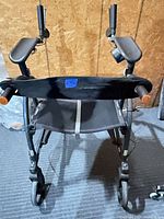 Front view of oversize rollator showing forearm supports, seat, wheels